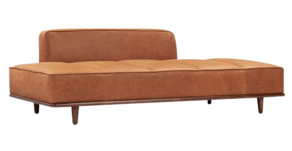 The tan leather lounge chair with wooden legs.