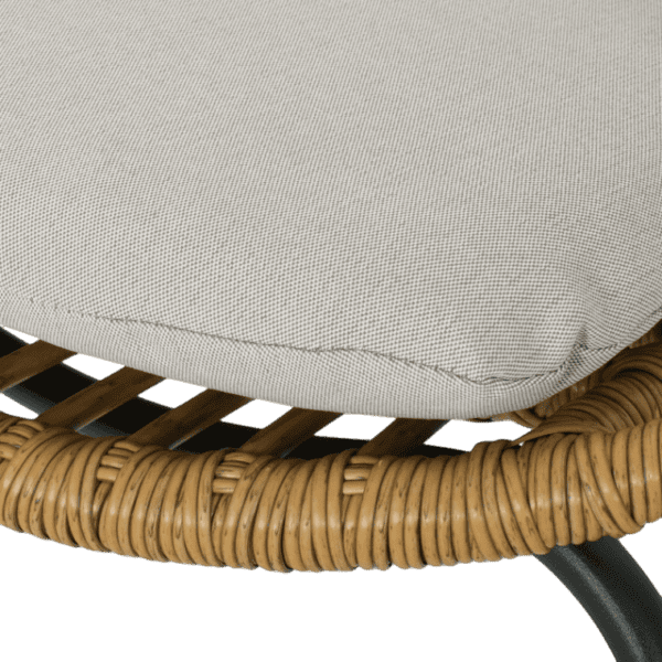 A cushion on a rattan chair.