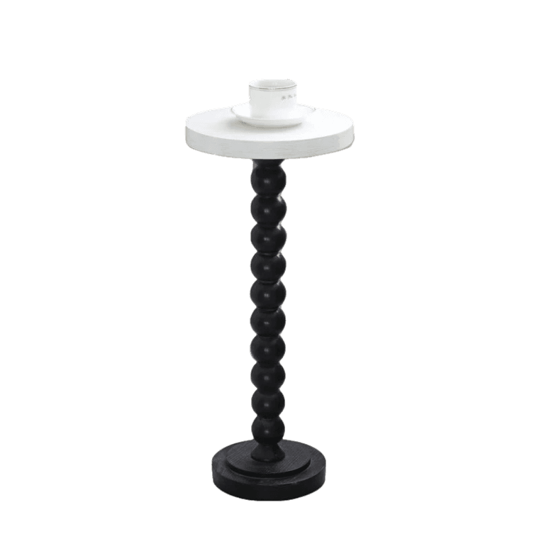 A black and white candle stand with a white top.