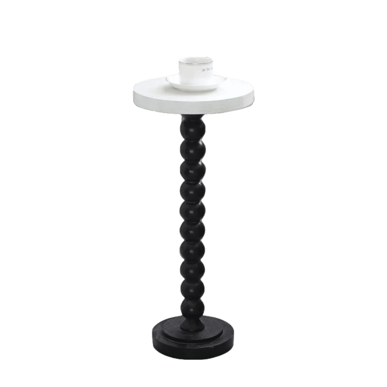 A black and white candle stand with a white top.