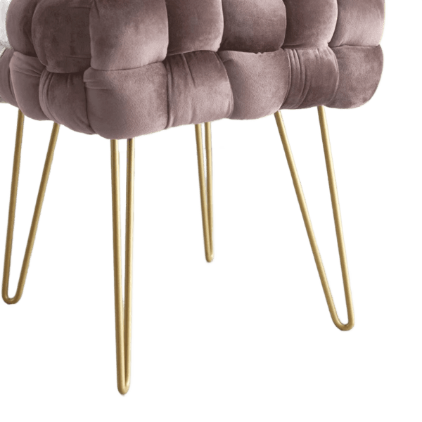 A pink velvet stool with gold legs.