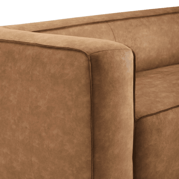 A close up of a brown leather sofa.