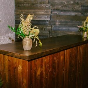 Peak Wooden Bar adorned with floral arrangements in a rustic style interior.