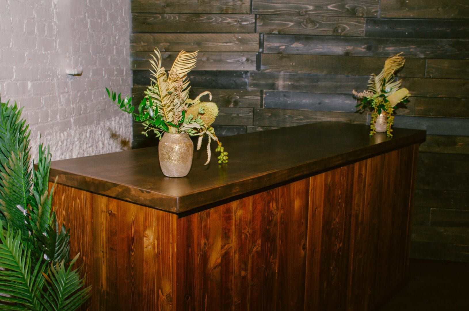 Peak Wooden Bar adorned with floral arrangements in a rustic style interior.